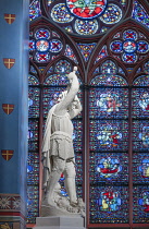 France, Paris, Cathedral de Notre Dame, Stained glass window with a statue of Saint George slaying the dragon in the restored cathedral after the fire of 2019.