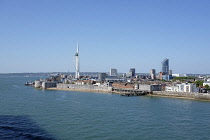 England, Hampshire, Portsmouth, Old Portsmouth, Square Tower. Sea defences. Old Portsmouth houses. Spinnaker Tower. Round Tower. Old Customs House. In distance HMS Queen Elizabeth, Portsmouth harbou...