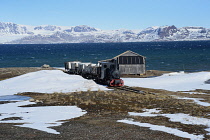 Norway, Svalbard, Ny-Alesund, Coal Mine train preserved by the Norwegian Railway Club in 1980.Kongsfjorden in the background.