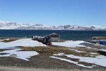 Norway, Svalbard, Ny-Alesund, Coal Mine train preserved by the Norwegian Railway Club in 1980.Kongsfjorden in the background.