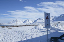 Norway, Svalbard, Ny-Alesund,Polar Bear warning sign overlooking Kongsfjorden.