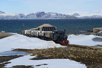 Norway, Svalbard, Ny-Alesund, Coal Mine train preserved by the Norwegian Railway Club in 1980.Kongsfjorden in the background.