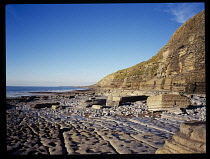 Wales, South Wales, Vale of Glamorgan, Dunraven Bay, near Southerndown showing layered tide worn rocks and cliffs.