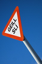 Republic of Ireland, County Galway, Yield or Give Way warning road traffic sign in the Irish or Gaelic language near the village of An Spideal.