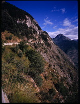 France, Isere, Narrow mountain road clinging to cliffside high above the Romanches valley summit of Pied Moutet.