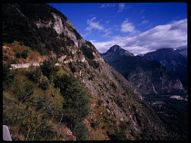 France, Isere, Narrow mountain road clinging to cliffside high above the Romanches valley summit of Pied Moutet.