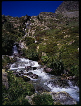 France, Isere, Unnamed stream from Lac de L'Ane flowing down rocky mountainside to Combe d'Olle and to Lac de Grand Maison.