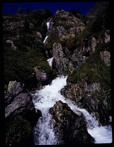 France, Isere, Unnamed stream from Lac de L'Ane flowing down rocky mountainside to Combe d'Olle and to Lac de Grand Maison.