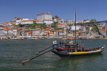 Portugal, Porto, Vila Nova de Gaia, Rabelo cargo boats on the River Douro with the Ribeira area of Porto in the background, Rabelo cargo boats were used for bringing wine from the vineyards in the Dou...
