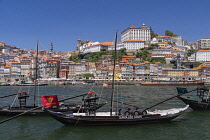 Portugal, Porto, Vila Nova de Gaia, Rabelo cargo boats on the River Douro with the Ribeira area of Porto in the background, Rabelo cargo boats were used for bringing wine from the vineyards in the Dou...