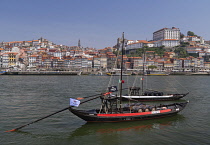 Portugal, Porto, Vila Nova de Gaia, Rabelo cargo boats on the River Douro with the Ribeira area of Porto in the background, Rabelo cargo boats were used for bringing wine from the vineyards in the Dou...