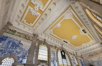 Portugal, Porto, Sao Bento railway station built in the early years of the 20th century with its colourful roof and some of the large panels of around twenty thousand azulejo tiles designed and painte...