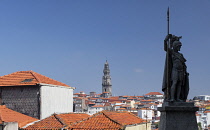 Portugal, Porto, Torre de Clerigos seen from the Terreiro da Se which is the square in front of Porto Cathedral with the statue known as O Porto or the Wandering Warrior in the foreground.