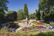 Portugal, Porto, Jardim do Palacio de Cristal or Crystal Palace Gardens, colourful flowerbed with a fountain in the centre.