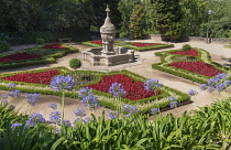 Portugal, Porto, Jardim do Palacio de Cristal or Crystal Palace Gardens, colourful flowerbed with a fountain in the centre.