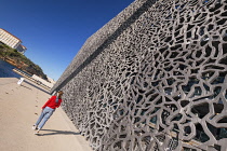 France, Provence, Marseille, Museum of European and Mediterranean Civilisations or MUCEM, a cube of 15,000 square metres or 160,000 sq ft surrounded by a latticework shell of fibre-reinforced concrete...