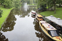 Latvia, Riga, Tourist boats on the canal in Bastejkalns Park.