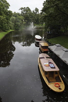 Latvia, Riga, Tourist boats on the canal in Bastejkalns Park.