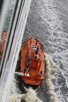 Latvia, Riga, Pilot boat on Daugava River collecting pilot from Swedish Cruise liner.